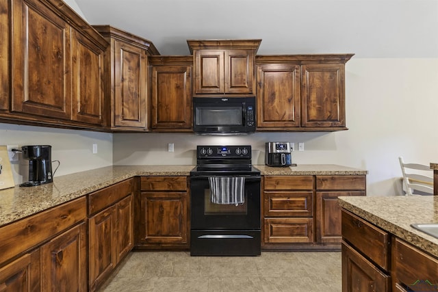 kitchen featuring black appliances and dark brown cabinets