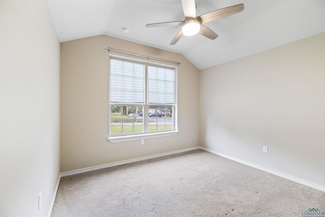 unfurnished room with baseboards, lofted ceiling, a ceiling fan, and carpet
