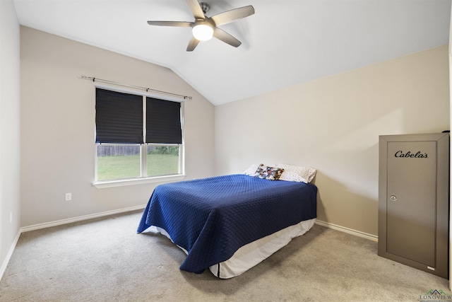 carpeted bedroom featuring vaulted ceiling, baseboards, and a ceiling fan