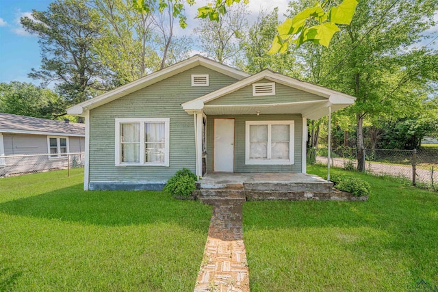 bungalow with fence, a porch, and a front yard