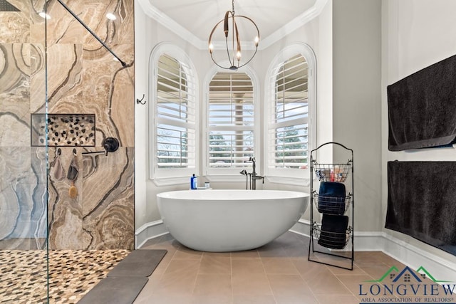 bathroom with tile patterned floors, an inviting chandelier, a healthy amount of sunlight, and ornamental molding