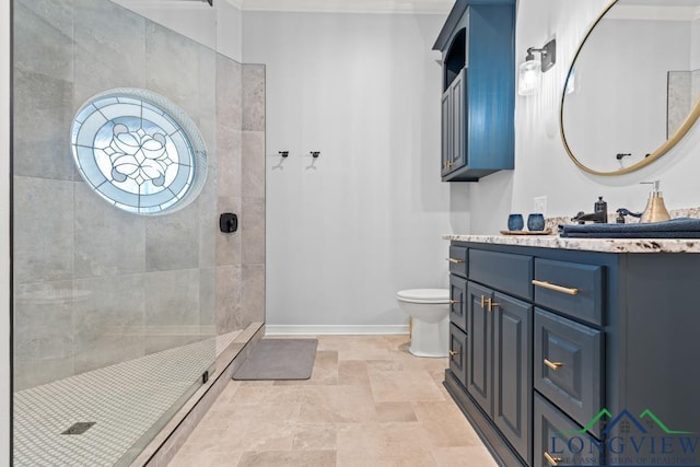 bathroom featuring a tile shower, vanity, and toilet