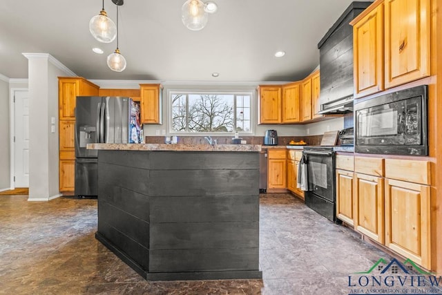 kitchen with pendant lighting, crown molding, black appliances, and a kitchen island