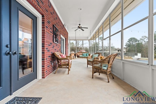 sunroom featuring ceiling fan