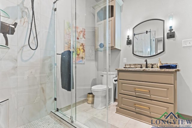 bathroom with vanity, an enclosed shower, and toilet