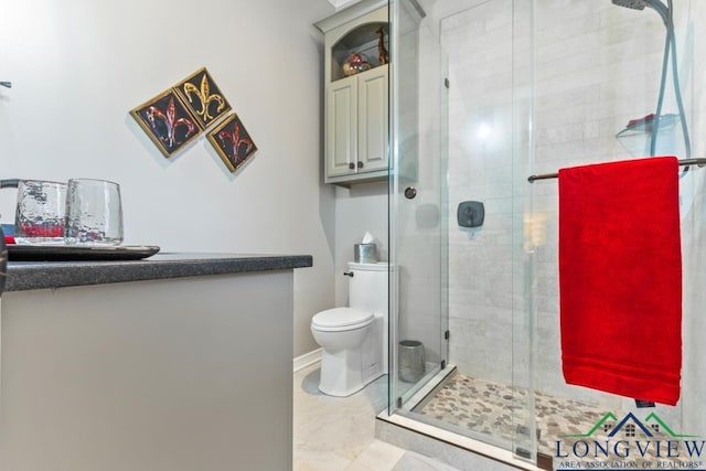 bathroom with an enclosed shower and toilet