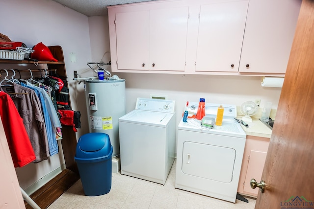 clothes washing area with separate washer and dryer, water heater, and cabinets