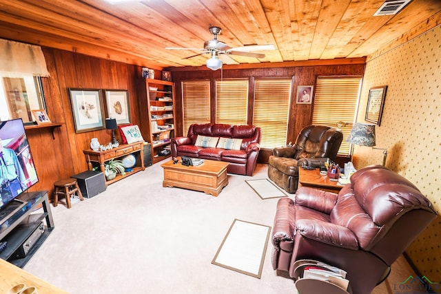 living room with carpet flooring, wood walls, ceiling fan, and wooden ceiling