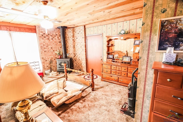 sitting room with carpet and a wood stove