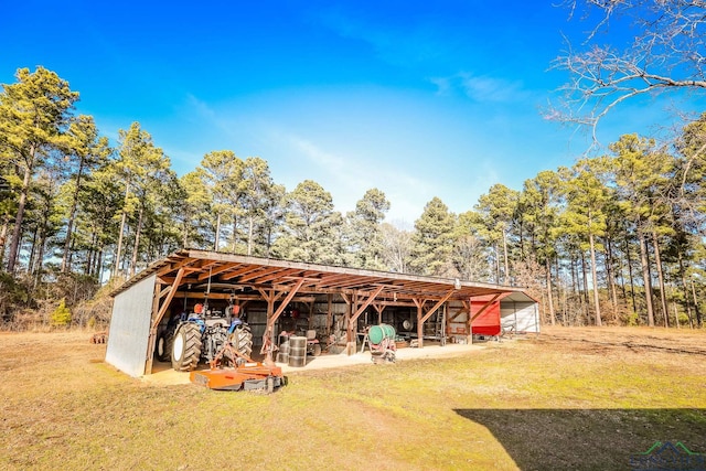 view of outbuilding featuring a lawn