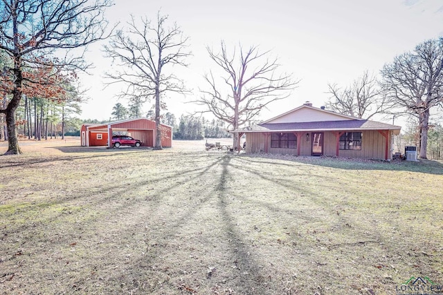 view of front of home with central AC unit and an outdoor structure