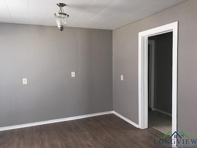 unfurnished room featuring dark wood-type flooring