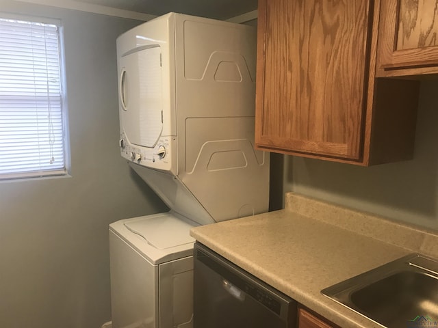 washroom featuring stacked washer and dryer and sink