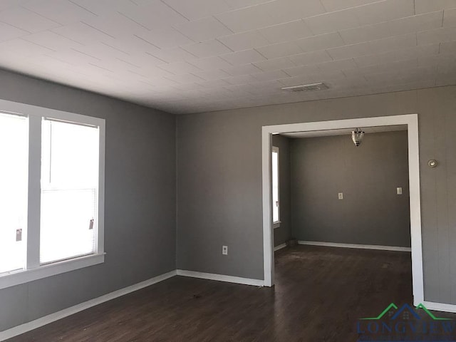 unfurnished room with dark hardwood / wood-style floors