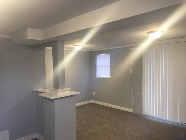 basement featuring dark colored carpet