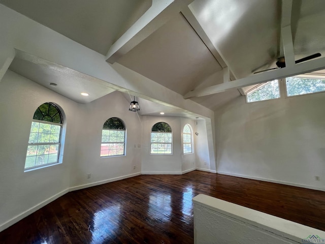 empty room with dark hardwood / wood-style flooring, lofted ceiling with beams, and ceiling fan