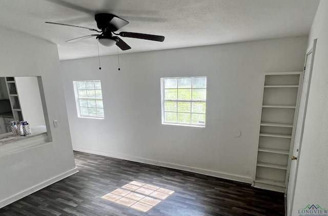 empty room featuring ceiling fan and dark wood-type flooring