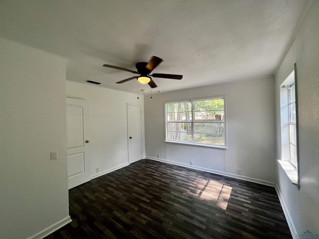 empty room featuring ceiling fan and dark hardwood / wood-style floors