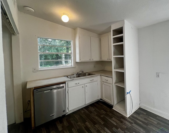 kitchen featuring dishwasher, sink, vaulted ceiling, a textured ceiling, and white cabinets