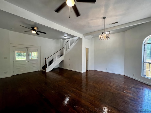 interior space with dark wood-type flooring and ceiling fan with notable chandelier