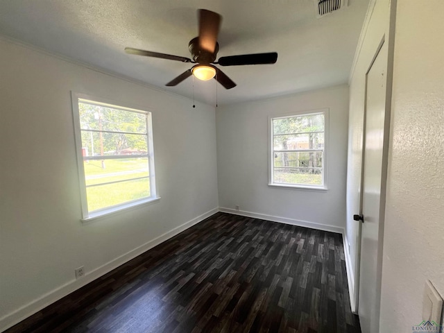 spare room featuring dark hardwood / wood-style floors, ceiling fan, and ornamental molding