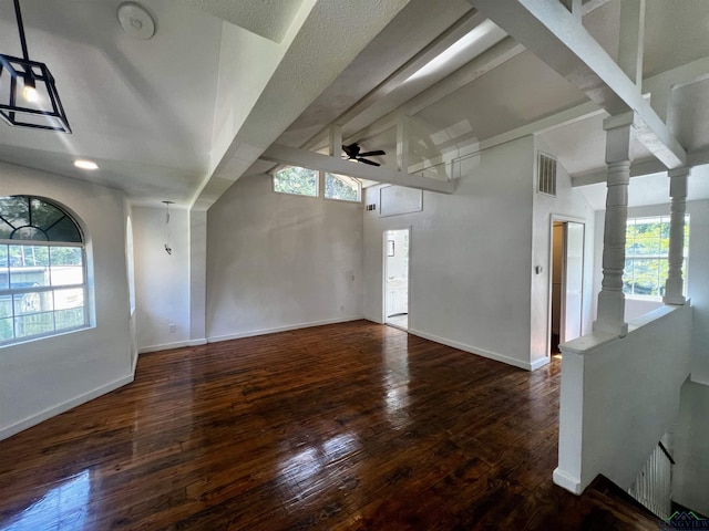 interior space with a wealth of natural light, ceiling fan, and dark hardwood / wood-style flooring