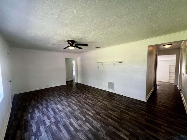 empty room with dark hardwood / wood-style floors, ceiling fan, and a textured ceiling