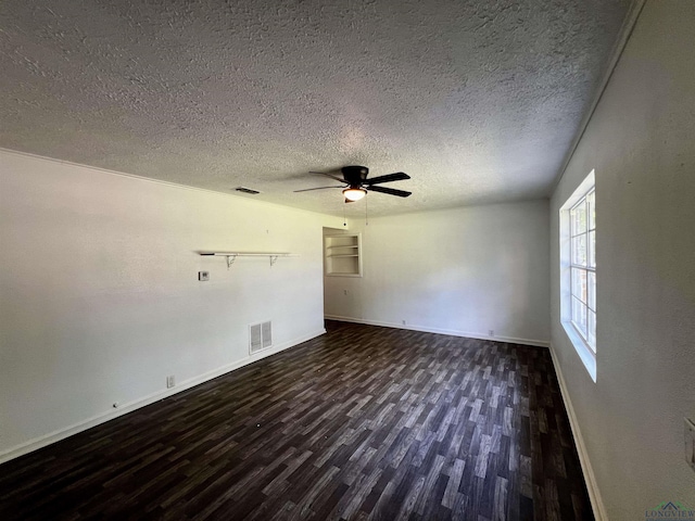 empty room with a textured ceiling, ceiling fan, and dark wood-type flooring