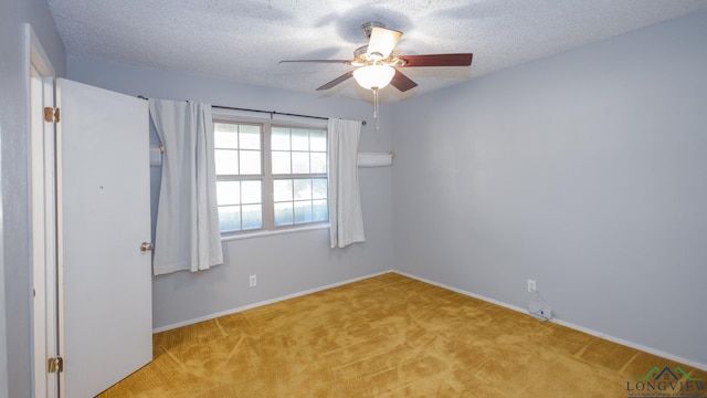 unfurnished room with a textured ceiling, ceiling fan, and light carpet