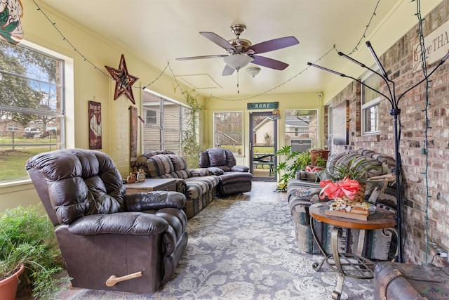 sunroom / solarium featuring ceiling fan