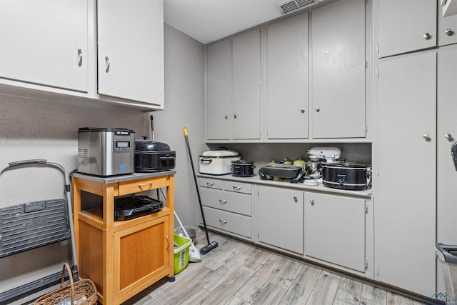 kitchen featuring white cabinetry and light wood-type flooring