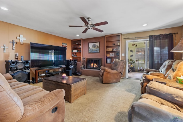 carpeted living room featuring a fireplace and ceiling fan