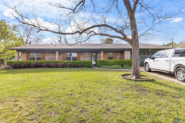 ranch-style house featuring a garage and a front lawn