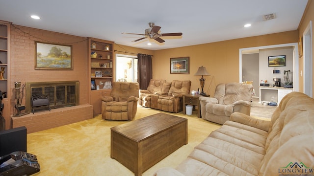 carpeted living room with ceiling fan and a brick fireplace