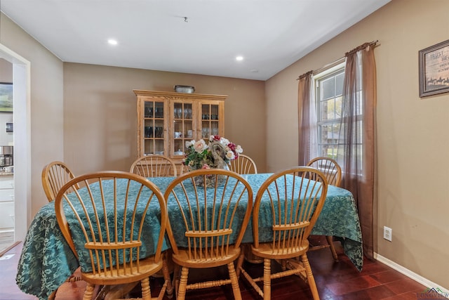 dining space with dark hardwood / wood-style floors