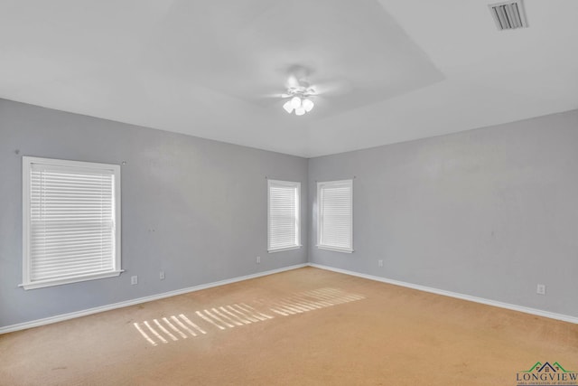 empty room featuring baseboards, visible vents, ceiling fan, and carpet flooring