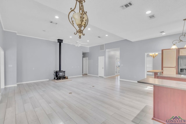 unfurnished living room featuring recessed lighting, visible vents, light wood-style flooring, and baseboards