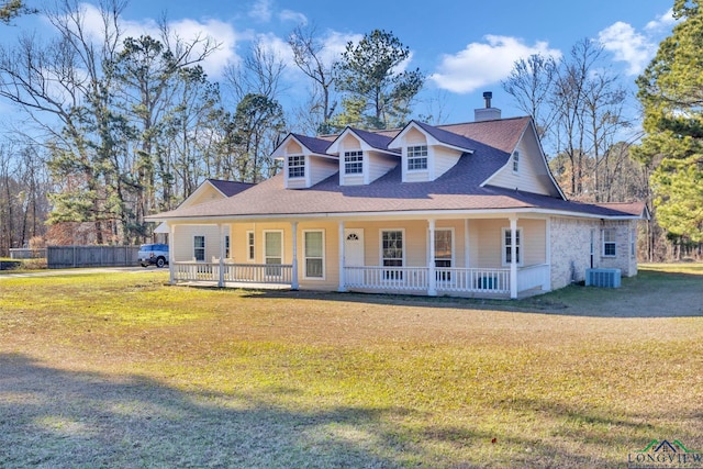 view of front of property with covered porch, a chimney, central AC, and a front yard