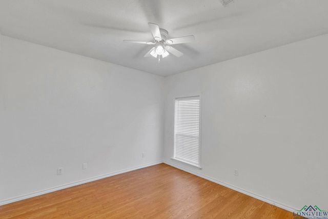 empty room with ceiling fan, light wood-style flooring, and baseboards