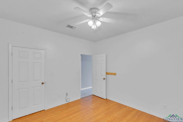 interior space featuring baseboards, light wood-style flooring, visible vents, and a ceiling fan