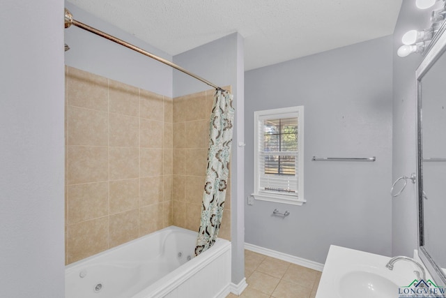 bathroom with a textured ceiling, tile patterned flooring, vanity, baseboards, and a combined bath / shower with jetted tub