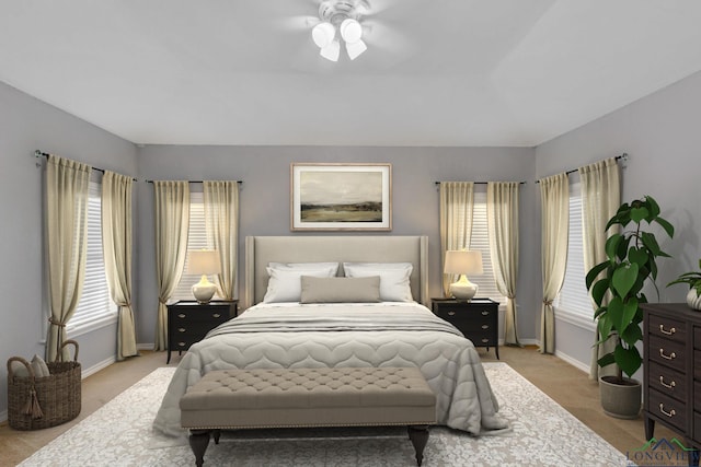 bedroom with baseboards, multiple windows, and light colored carpet