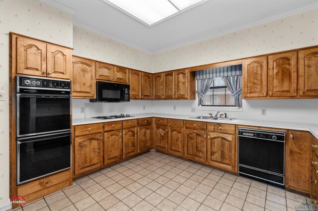 825 University Dr, Carthage, TX 75633 - kitchen featuring black appliances, a sink, brown cabinetry, light countertops, and crown molding