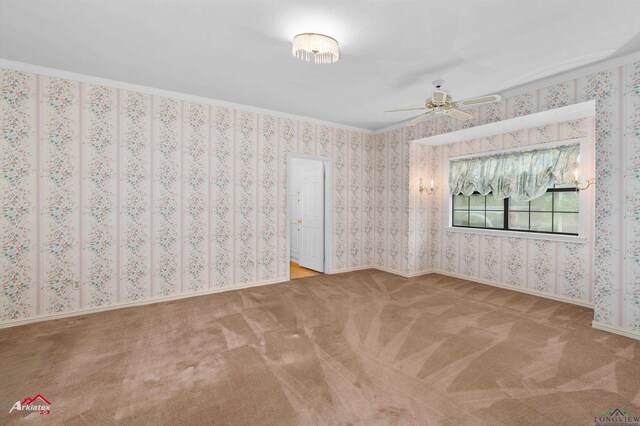 825 University Dr, Carthage, TX 75633 - unfurnished room featuring carpet floors, a ceiling fan, and crown molding