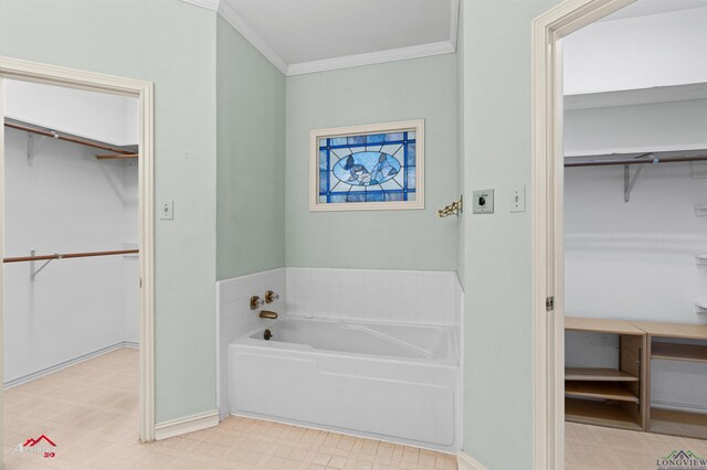 825 University Dr, Carthage, TX 75633 - bathroom with tile patterned floors, a bath, a spacious closet, crown molding, and baseboards