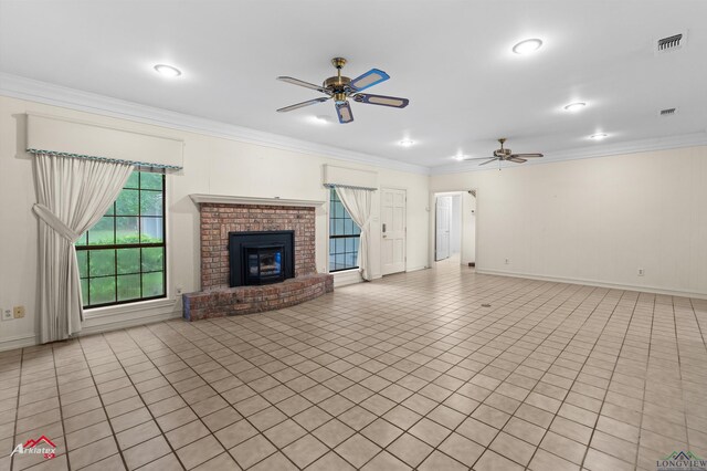 825 University Dr, Carthage, TX 75633 - unfurnished living room with ceiling fan, crown molding, a brick fireplace, baseboards, and light tile patterned flooring