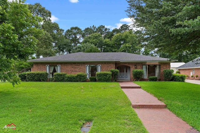 825 University Dr, Carthage, TX 75633 - single story home featuring a front yard, brick siding, and a shingled roof