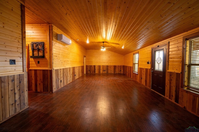 spare room featuring an AC wall unit, wooden walls, lofted ceiling, dark hardwood / wood-style flooring, and wooden ceiling