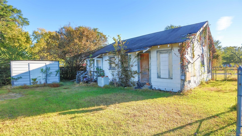 rear view of house with a yard