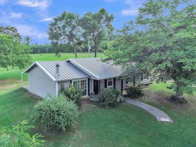 3738 Fm 161 S, Hughes Springs, TX 75656 - view of front of house with a standing seam roof, a metal roof, and a front yard